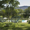 2 modern design chairs and the private pool of Casa delle Marche